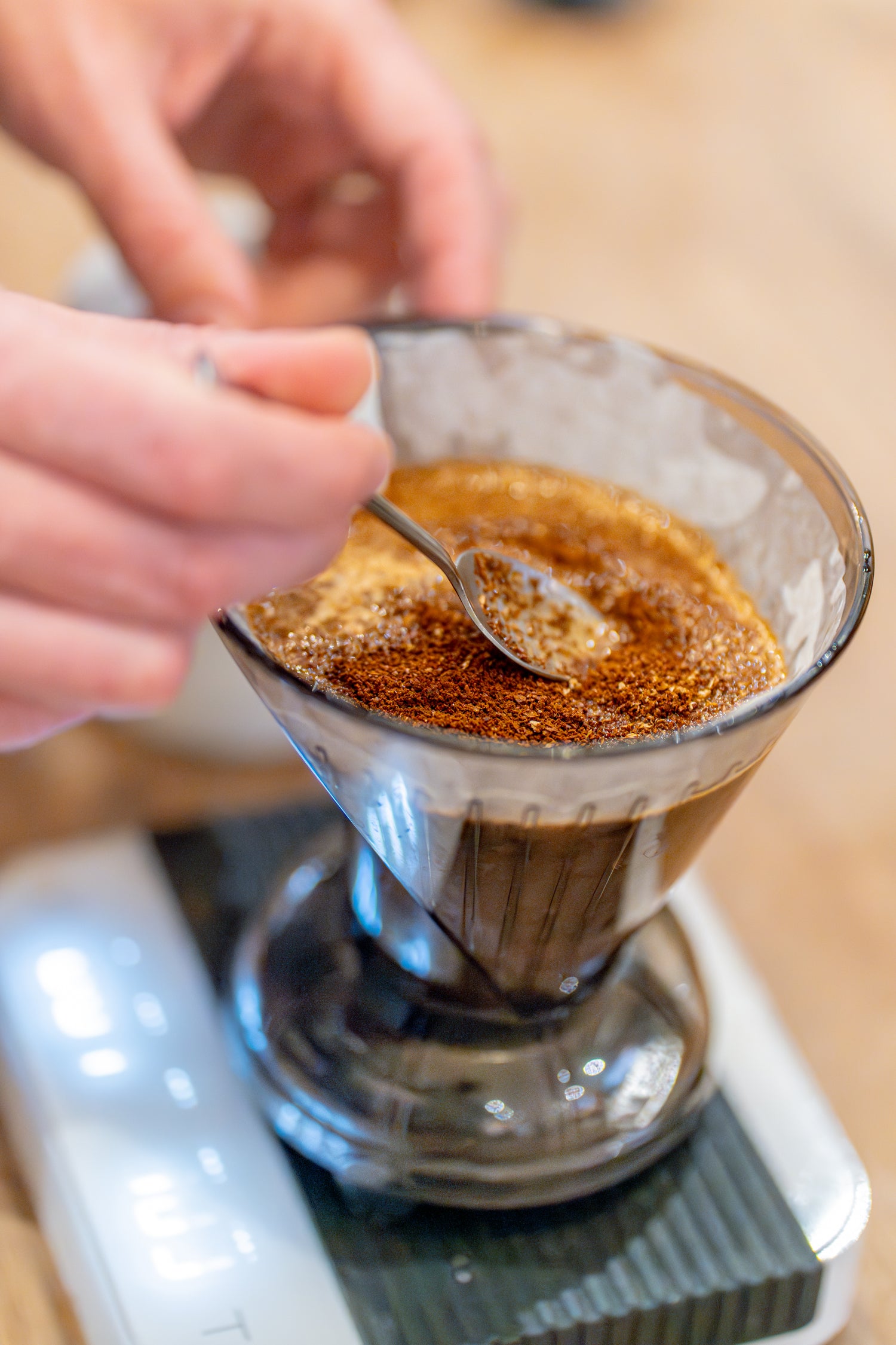 Single Origin ground coffee being stirred in a Clever Dripper