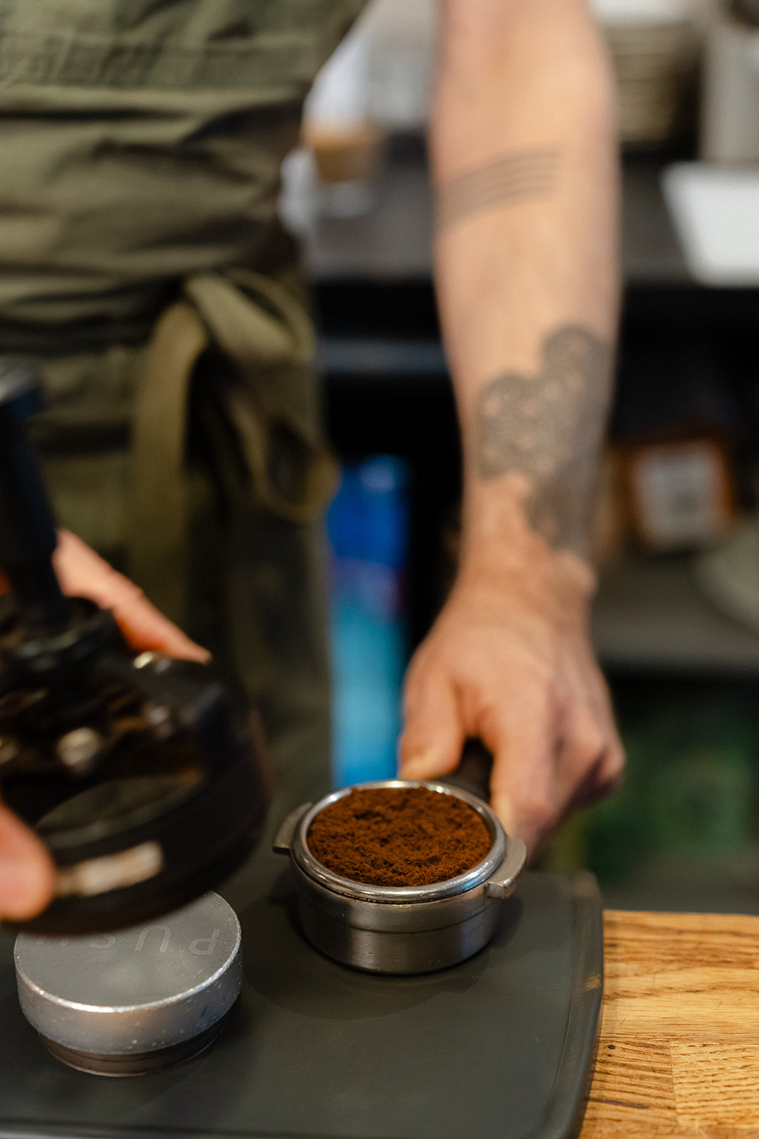 Espresso grounds in a portafilter basket after using a rotating needle distribution tool, before tamping.