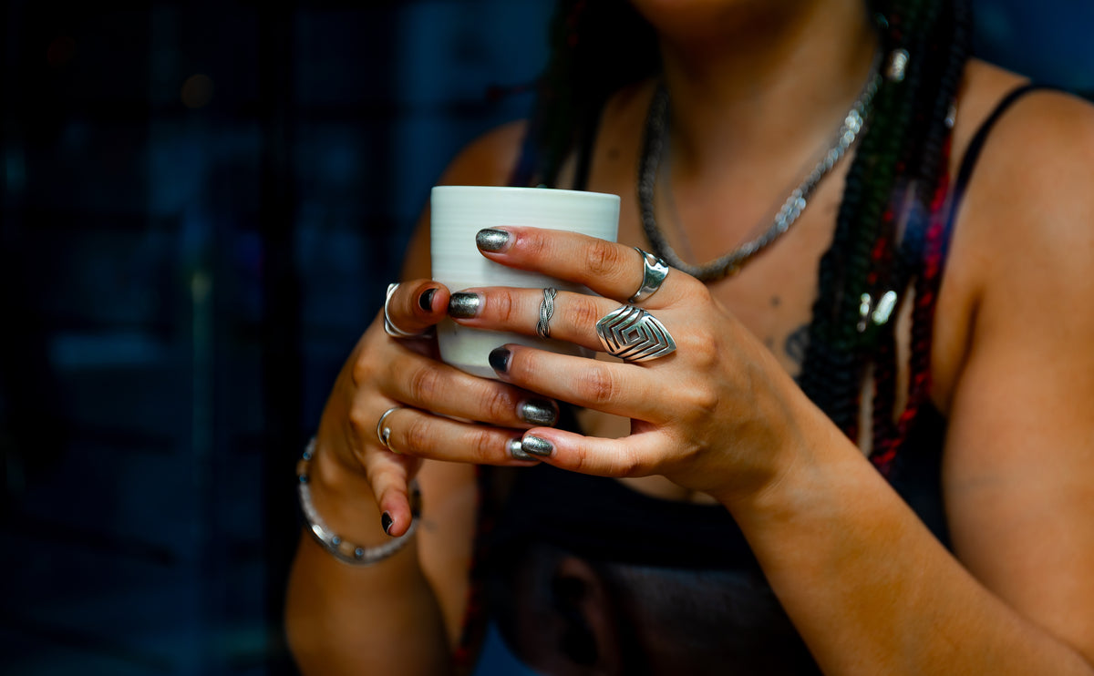 Hands holding simple minimal coffee cup